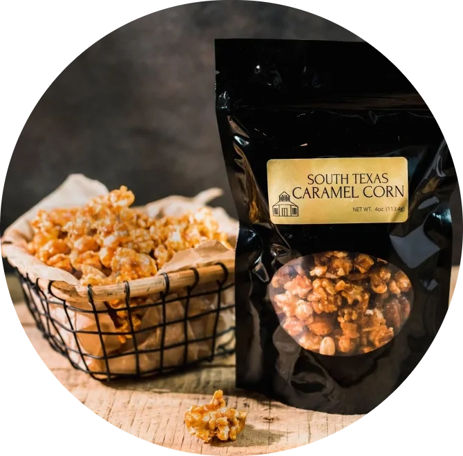 South Texas Caramel Corn snack bag with scattered caramel popcorn on a wooden surface