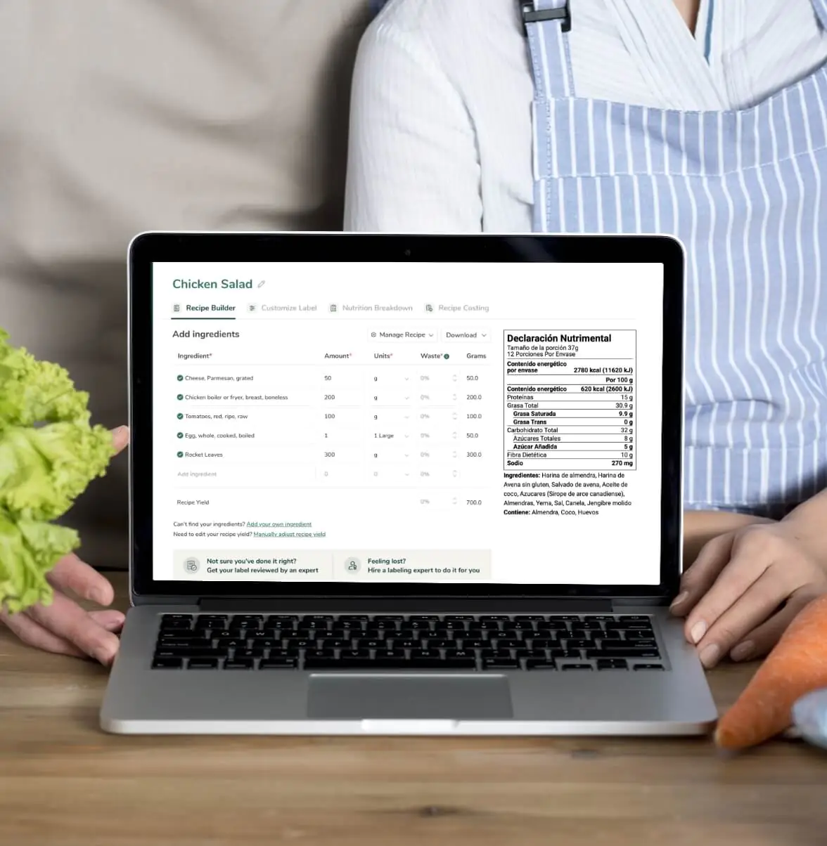 Chef using Food Label Maker on laptop displaying Mexico Declaracion Nutrimental with vegetables nearby